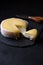 Butter soft creamy sheep cheese from Seia region Portugal on black slate board