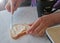 Butter is spread on bread. Homemade bread toast with butter on a wooden table, coffee for breakfast