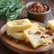 Butter with sun dried tomatoes and herbs on wooden cutting board. Sun dried tomatoes creamy cheese for cooking, bruschettas,