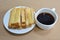 Butter toasted bread topping sugar and black coffee