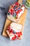 Buttercream berry pound cake with slices, colorful fruits and berries on top