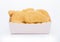 Buttered chicken nuggets in kids paper square cup for fast food meals on white background