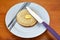 Buttered English crumpet with knife