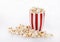 Buttered popcorn in a striped bowl over white background