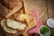 Buttered slices of rye bread with bowls of parsley