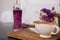 Butterfly pea water and macaron and hot coffee mug in the front