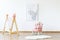 Butterfly poster, wooden clothes hanger and pink armchair with a