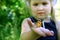 Butterfly sitting on the hand of a child. Child with a butterfly. Butterfly painted lady on the hand of a little girl. Selective f