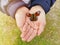 A butterfly sitting in the hands of a girl. Delicate red and black butterfly wings on the child\'s fingers
