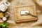 Buttering a slice of bread on wooden cutting board