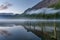 Buttermere Lake At Dawn With Mist And Reflections.