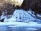 Buttermilk Falls frozen in winter cold in Fingerlakes