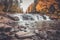 Buttermilk Falls surrounded by brilliant fall foliage in Long Lake NY, ADK Mountains