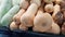 Butternut pumpkins are placed on shelves for sale along with other agricultural products