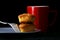 Butterscotch bars on a plate, coffee mug and a fork