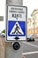 The button for switching of the traffic light at the crosswalk. The Russian text - For transition press the button, wait