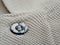 Button on a vintage dull brown shirt close up