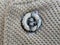 Button on a vintage dull brown shirt close up