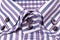 Buttons on a striped purple shirt