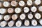 Butts of round wooden turned round bars prepared for sale, wooden background