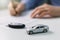 Buy new car concept - signing contract in dealer office