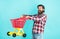 buy and purchase. mature guy in checkered shirt go shopping. stylish male carry shopping cart. bearded man with