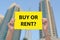 Buy or Rent Property Sign in Hand