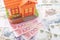 Buy or rental the house concept. Close up several banknote currency Chinese Yuan (CNY or RMB) and house model