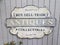 Buy sell trade antiques collectibles sign on grey wall