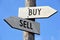 Buy and sell - wooden signpost