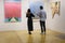 Buyer Evaluating the Purchase of Works in a Modern Art Gallery