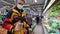 Buyer with a hand scanner in his hands and a medical mask on his face in a supermarket