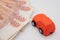 buying a car in rubles toy car on the background of banknotes