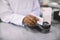 Buying with credit card in the pharmacy. Cropped image of hands of African woman pharmacist swiping credit card of