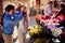 Buying Flowers.Man surprises woman at flower shop on the street