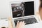 Buying online. Woman choosing car using laptop, closeup