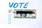 Buying votes of voters concept. Vote, dollars on a white background