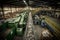 a buzzing and busy recycling center, with conveyor belts and machines sorting recyclables into different bins