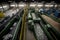 a buzzing and busy recycling center, with conveyor belts and machines sorting recyclables into different bins