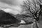 Bw cloudy mountain landscape with tree, river and town Mtskheta