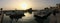 Byblos harbour at dusk, with the silhouettes of fishermen`s boats and the flag of Lebanon  on the mediterranee, Lebanon