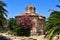 Byzantine Church of the Holy Apostles in Athens in the summer surrounded by plants against the blue sky.