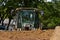 Cab of a bulldozer appears above the sand pile