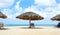 Cabana, parasol. White sand beach. Blue sea water and dramatic clouds. Oranjestad, Aruba. Eagle Beach.