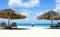 Cabana, parasol. White sand beach. Blue sea water and dramatic clouds. Oranjestad, Aruba. Famous Eagle Beach