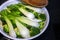 Cabbage and broccoli stew in pan on an electric stove