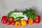 Cabbage, fennel, parsley, tomato, paprika, cucumber on a gray canvas