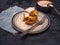 Cabbage oladi with sour cream. Against a dark background, under the plate is a blue denim napkin