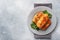 Cabbage rolls with beef, rice and vegetables on the plate. Stuffed cabbage leaves with meat. Gray concrete table Copy space