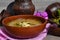 Cabbage soup made from sauerkraut with red pepper. Russian cuisine, ceramic bowls